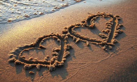 two hearts on sand